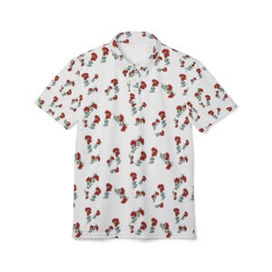 May include: A white short-sleeved polo shirt featuring a repeating pattern of red flowers with green stems and leaves. The shirt has a classic collar, a button-down placket, and a straight hemline, providing a clean and structured appearance.