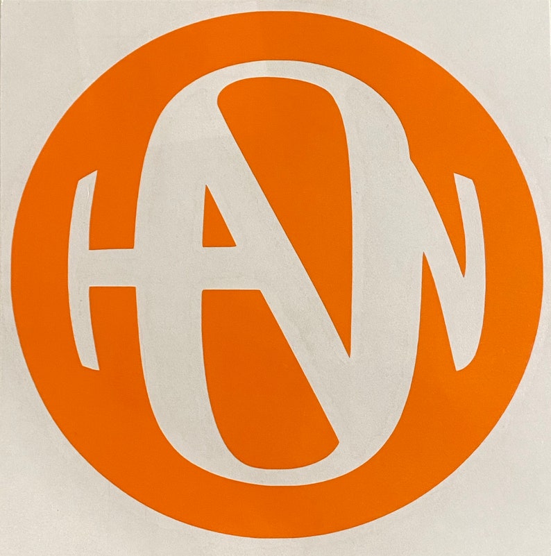 May include: A white monogram of the letters "HAN" in a circle on an orange background.