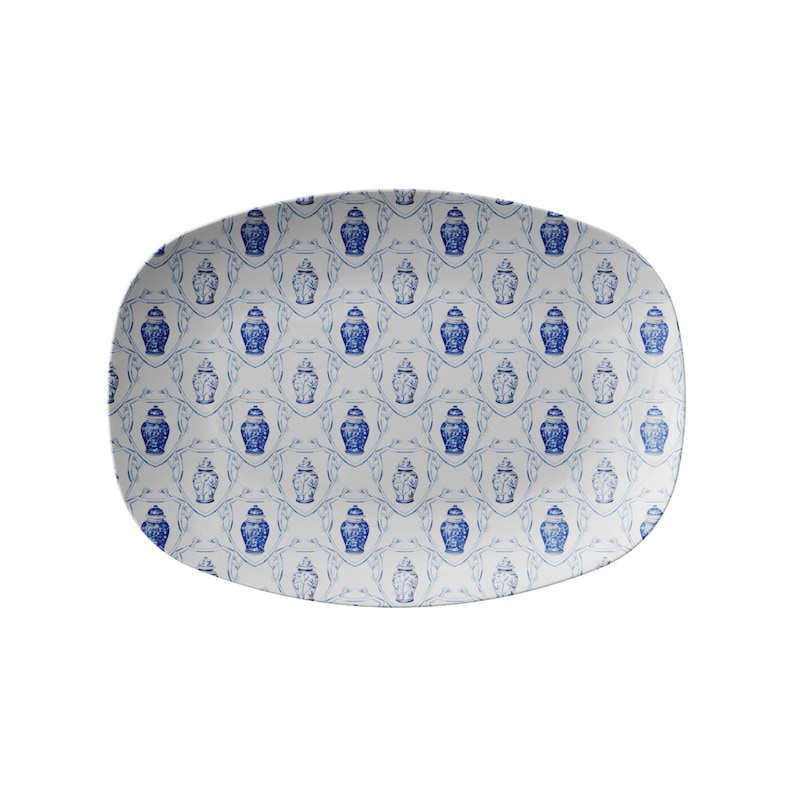 May include: An oval serving platter with a repeating pattern of blue and white decorative jars. The jars are in a classic style, set against a white background with a delicate leaf design.