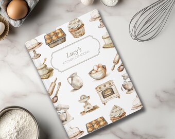 Puede incluir: Una cubierta de libro de cocina blanca con ilustraciones de acuarela de utensilios de cocina e ingredientes para hornear. El título del libro de cocina es "Lucy's Kitchen Creations".