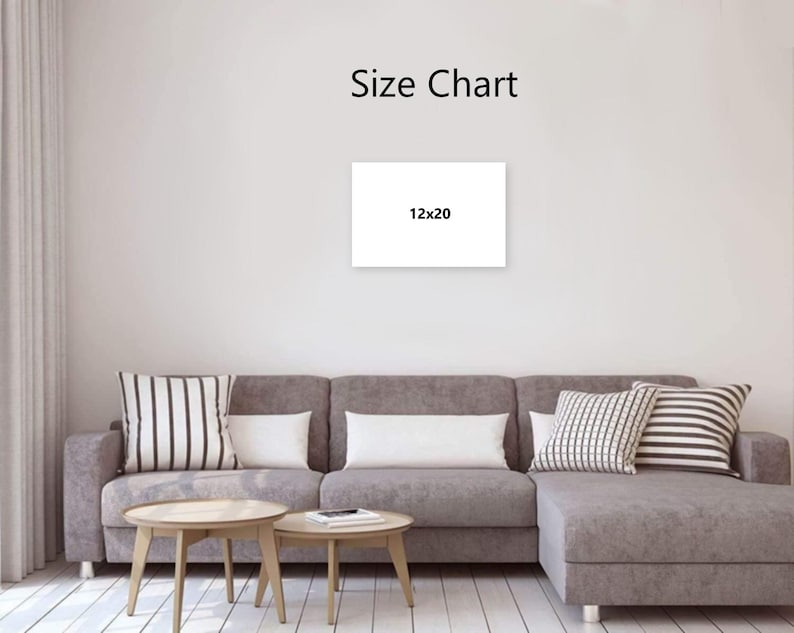 May include: A white canvas with the text "Size Chart" and "12x20" displayed on a wall. The canvas is above a gray sectional sofa with decorative pillows and two wooden coffee tables.