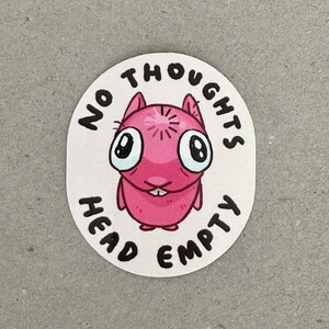 May include: Pink cartoon character with large eyes and a star on its head. The character is surrounded by the text "No Thoughts Head Empty".
