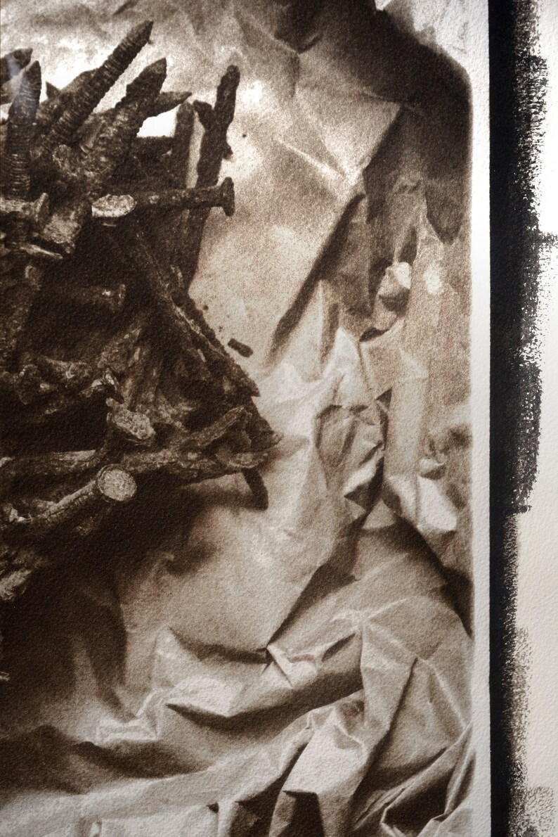 May include: A close-up of a pile of rusty metal nails and screws on a crumpled brown paper background.