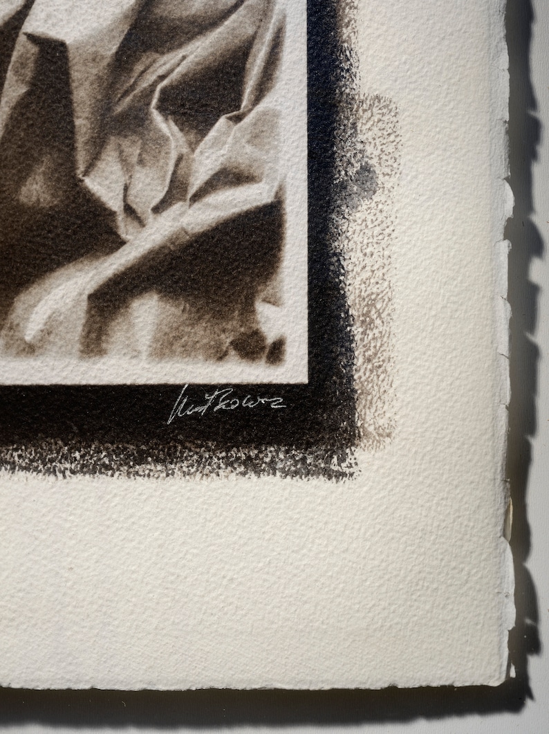 May include: A black and white photograph of a draped fabric with a black border and the artist's signature "Matt Rowe" in the bottom right corner.
