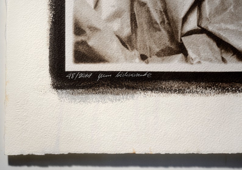May include: A black and white photograph of crumpled fabric. The image is numbered 48/2014 and signed "Jean Bil&eacute;venede".