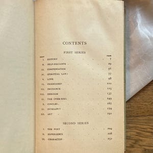 May include: Open book with a contents page visible. The page is aged with a tan color and features a list of essays with page numbers. The title "CONTENTS" is at the top, with "FIRST SERIES" and "SECOND SERIES" headings.
