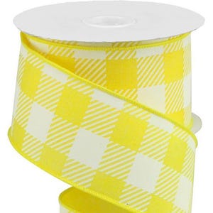 May include: A spool of yellow and white gingham ribbon. The ribbon is a bright yellow with a classic checkered pattern in white. The edges are finished with a yellow trim. Perfect for crafts and gift wrapping.