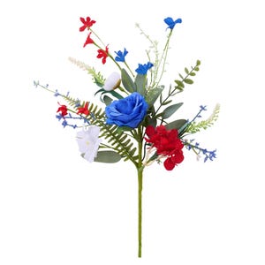 May include: A floral arrangement featuring a vibrant mix of red, white, and blue flowers. The bouquet includes a large blue rose, red blooms, and white flowers, complemented by green foliage. The arrangement is perfect for patriotic or celebratory occasions.