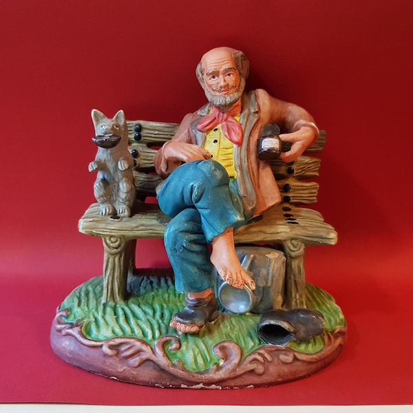 Personnages faience porcelaine vieil homme voyageur sur un banc avec son chien faisant l'aumone d'inspiration Capodimonte made in Portugal