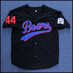 May include: Black baseball jersey with the word "Beers" in red and blue lettering on the front. The number "44" is on the left sleeve in red.