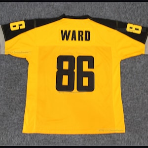May include: Yellow football jersey with black and grey trim. The back of the jersey has the name "WARD" and the number "86" in black.