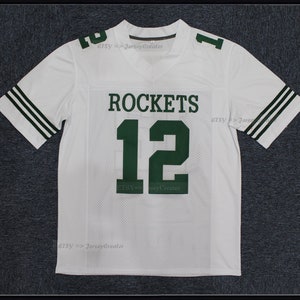 May include: White jersey with green and white stripes on the sleeves. The jersey has the word "ROCKETS" and the number "12" on the front in green.