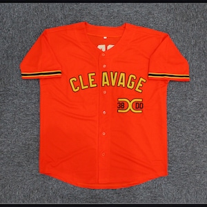 May include: Red baseball jersey with black and gold trim. The jersey has "CLE AVAGE" written across the chest in yellow letters with a black outline. The number "38" and the letter "X" are printed in yellow with a black outline below the text.