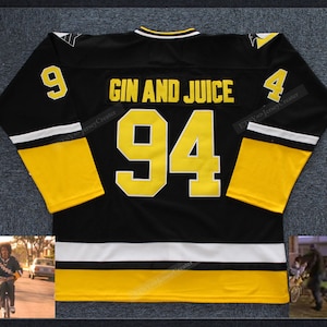 May include: Black and yellow hockey jersey with the text "GIN AND JUICE" and the number "94". The jersey has white and yellow stripes on the sleeves and bottom. The number "9" is on the left sleeve and "4" on the right sleeve.
