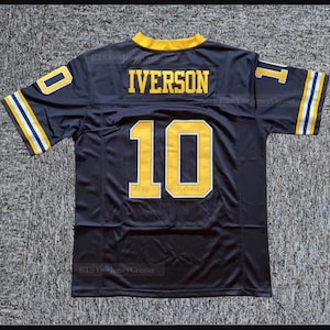 May include: Black football jersey with yellow and white stripes on the sleeves. The number 10 and the name "IVERSON" are printed on the back in yellow.