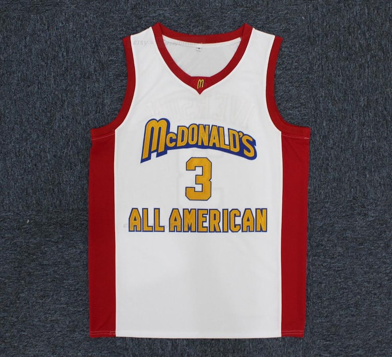 May include: White basketball jersey with red accents and the McDonald's logo. The jersey features the number 3 in gold and the words "ALL AMERICAN" in gold lettering.