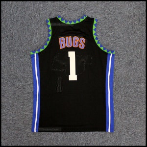 May include: Black basketball jersey with white and blue trim. The back of the jersey has the number "1" and the name "BUGS" in orange letters.