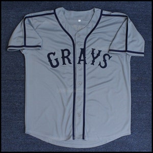 May include: A gray baseball jersey with navy blue trim and the word "GRAYS" in navy blue lettering.
