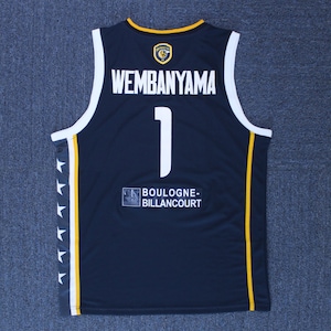May include: A navy blue basketball jersey with yellow accents. The back of the jersey has the name "WEMBANYAMA" and the number "1" in white. The team name "BOULOGNE-BILLANCOURT" is printed on the bottom of the jersey.