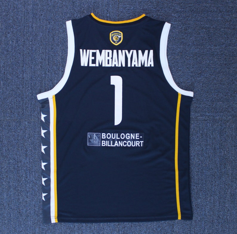 May include: A navy blue basketball jersey with yellow accents. The back of the jersey has the name "WEMBANYAMA" and the number "1" in white. The team name "BOULOGNE-BILLANCOURT" is printed on the bottom of the jersey.