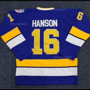 May include: A blue hockey jersey with yellow and white stripes. The number "16" and the name "HANSON" are printed on the back in gold.