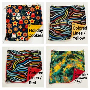 May include: Four square fleece hammocks with metal corner grommets and clips. Top left: Holiday Cookies pattern with yellow backing. Top right: Colored Lines pattern with yellow backing. Bottom left: Colored Lines with red backing. Bottom right: Greenish/Yellowish tie-dye with red backing.