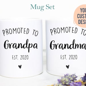May include: Two white ceramic mugs featuring black text. The left mug reads PROMOTED TO Grandpa EST. 2020 with a small heart. The right mug reads PROMOTED TO Grandma EST. 2020 with a small heart. A circular peach graphic says YOUR CUSTOM DESIGN.