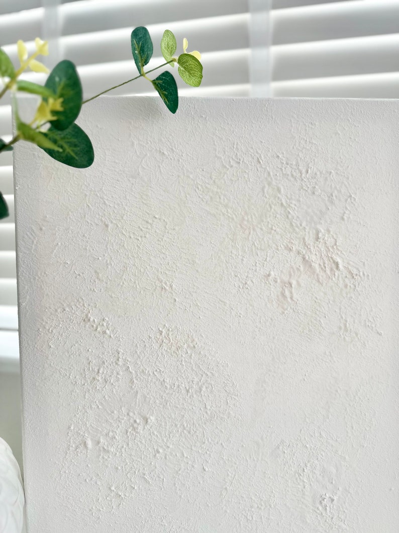May include: White textured canvas board with a rough, uneven surface. The board is blank and ready for painting or other creative projects.