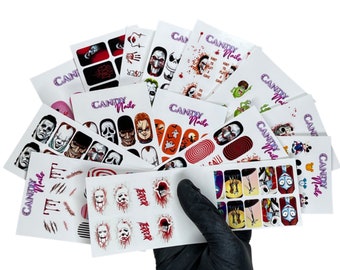 May include: A selection of Halloween nail art transfers with horror movie characters, blood effects, and spooky designs. The transfers are on white cards with the "Candy Nails" logo in purple.