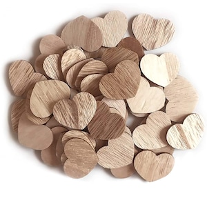 May include: A collection of small, wooden heart shapes in various shades of brown. The hearts have a natural wood grain pattern, with some appearing lighter and others darker. They are scattered on a white surface, creating a rustic and charming aesthetic.