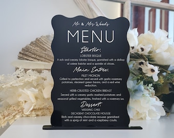 May include: Black chalkboard menu sign with white text. The menu includes a starter, main entree, and dessert. The starter is lobster bisque, the main entree is filet mignon or herb-crusted chicken breast, and the dessert is wedding cake or decadent chocolate mousse.