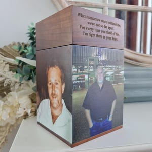 May include: A wooden memorial box with two photographs of a man. The top of the box has engraved text that reads, "When tomorrow starts without me, we're not so far apart. For every time you think of me, I'm right there in your heart."