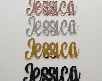 May include: Four acrylic name plaques with the name "Jessica" in different colors: rose gold, silver, gold, and black.