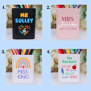 May include: Four different pencil holders with personalized designs. The first is black with the text "MR SULLEY" and colorful school supplies. The second is pink with the text "MRS Jacobs BEST TEACHER". The third is white with a rainbow and the text "MISS KING". The fourth is white with the text "Ms Rachael YOU JUST HAP-pen TO BE JUST ink-CREDIBLE" and a red apple.
