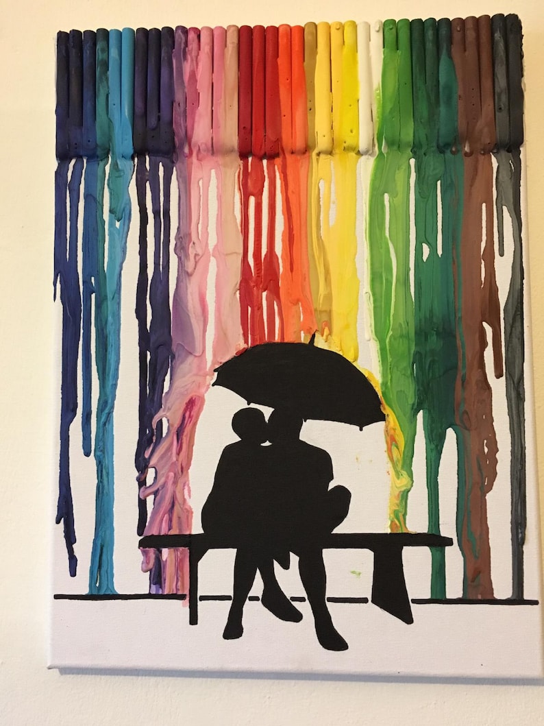 May include: A colorful abstract painting on canvas featuring a silhouette of two people sitting on a bench under an umbrella. The background is a rainbow of melted crayon wax.