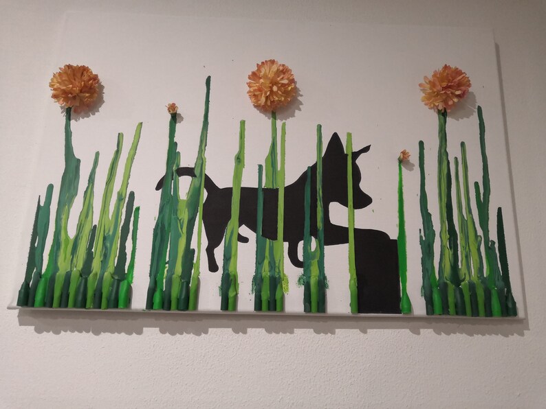 May include: A black silhouette of a dog walking through a field of green grass with orange flowers. The grass is made of melted crayons.