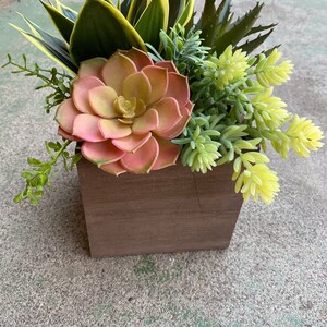 Faux succulent arrangement in wood box