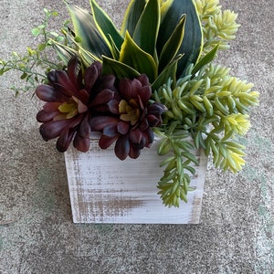 Faux succulent arrangement in white wood box