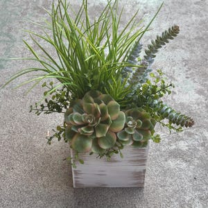 Faux succulent arrangement in white wood box