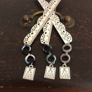 eye chart and round acetate eyeglasses lace optician pd ruler