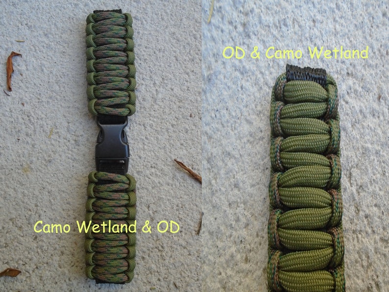 May include: Two green and brown camouflage paracord watch bands with black buckles. The band on the left is labeled "Camo Wetland & OD". The band on the right is labeled "OD & Camo Wetland".