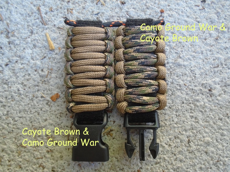 May include: Two paracord bracelets with black buckles. The bracelet on the left is brown and the bracelet on the right is camouflage with green, brown, and black colors. The text "Coyote Brown & Camo Ground War" is written below the bracelets.