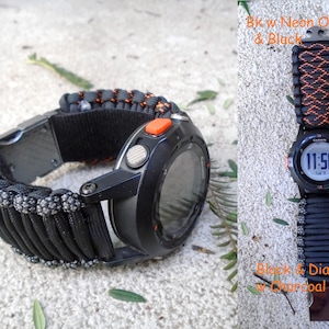 May include: Black Garmin watch with a black and neon orange paracord band. The watch face displays the time as 11:58. The watch band is made of woven nylon cord. The watch has an orange button.