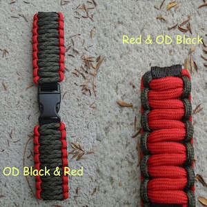 May include: Two paracord bracelets, one with red and olive green paracord, the other with olive green and red paracord. Both bracelets have a black plastic buckle.