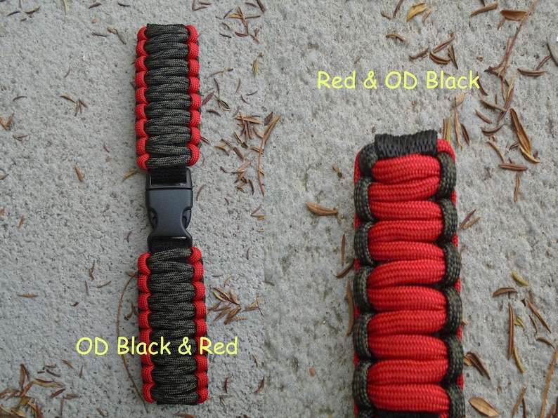 May include: Two paracord bracelets, one with red and olive green paracord, the other with olive green and red paracord. Both bracelets have a black plastic buckle.