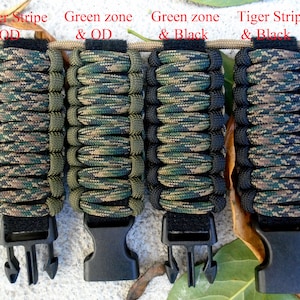 May include: Four paracord bracelets in different camouflage patterns. The bracelets are made with green, black, and brown paracord. Each bracelet has a black plastic buckle.