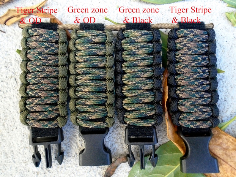 May include: Four paracord bracelets in different camouflage patterns. The bracelets are made with green, black, and brown paracord. Each bracelet has a black plastic buckle.