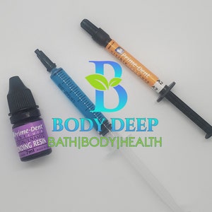 May include: Three bottles of dental bonding resin, one clear, one blue, and one purple. The bottles are labeled "Prime-Dent" and have the text "visible light cure" and "A2".