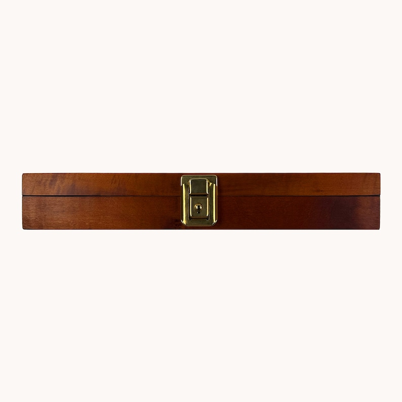 May include: A wooden box with a brass latch. The box is closed and has a natural wood finish.