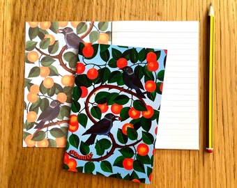 A6 jackdaws and oranges notebook; notebook with vibrant bird and fruit design on covers; eco-friendly recycled paper; 48 lined pages